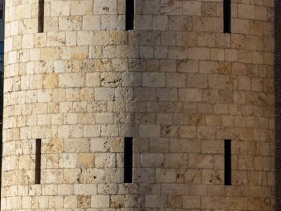 a tall brick tower sitting next to a brick wall