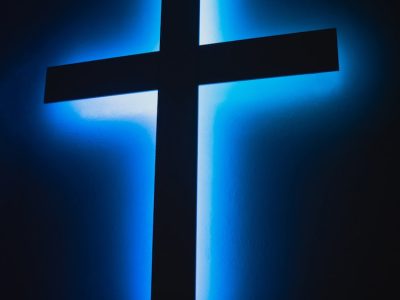 brown wooden cross on orange background