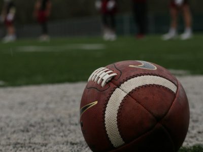 a football sitting on top of a lush green field