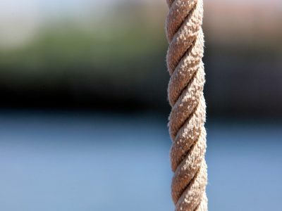 a close up of a rope with water in the background