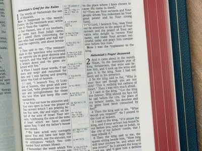 a book of nehemiah on a wooden table