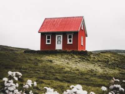 red and white house surround green grass field
