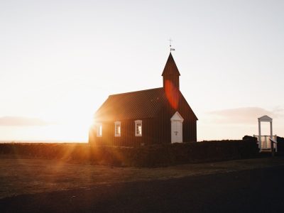 brown chapel surrounded green grass