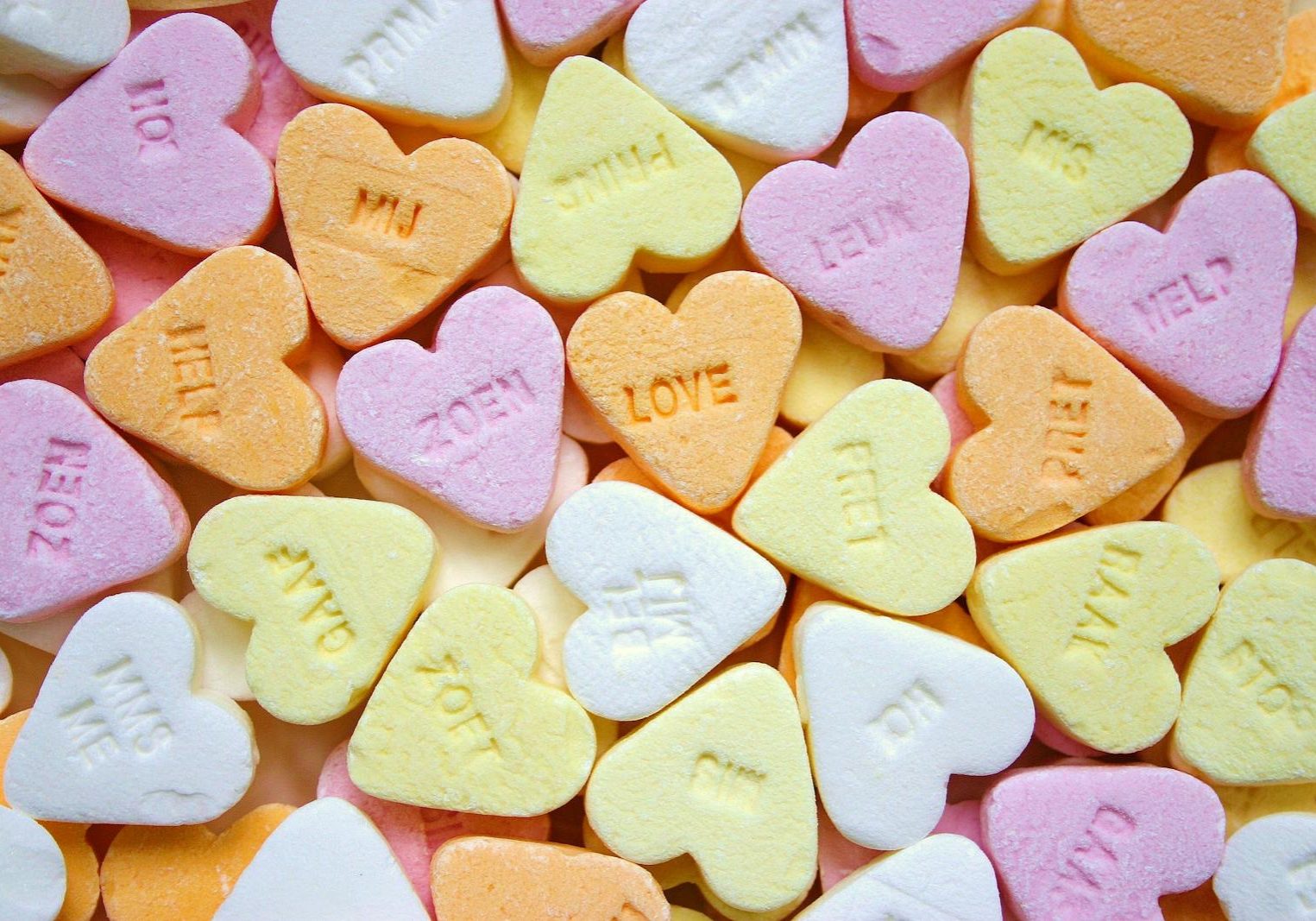 Colorful heart-shaped candies with embossed love messages, perfect for romance themes.