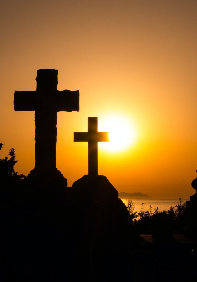 silhouette of cross during sunset