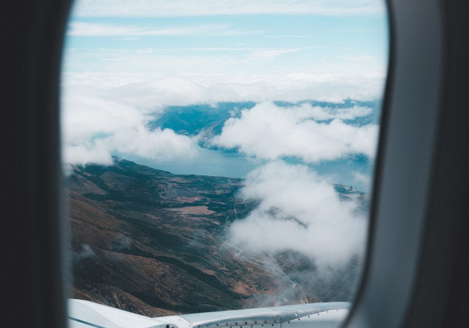 aerial photo of mountains and clouds under blue sky