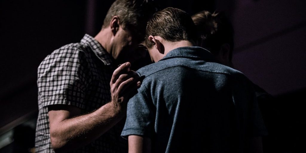 men touching each other's foreheads